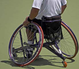 man in short and T-shirt  in a wheelchair